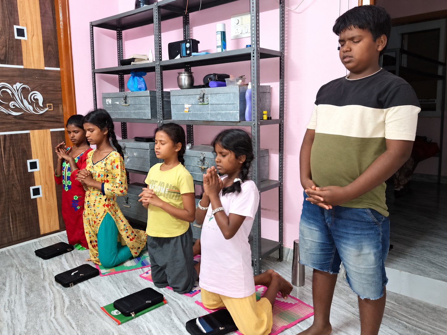 Children sharing a moment of prayer at the foundation